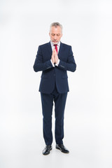 Mature businessman praying