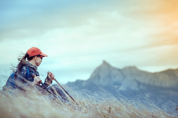 Young traveler with backpack standing on the big stones