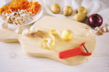 peeled potatoes and ingredients for soup