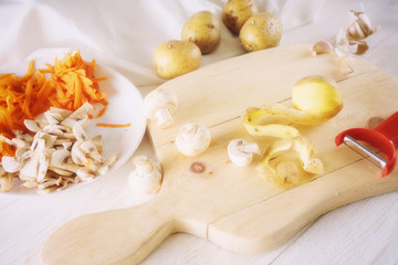 peeled potatoes and ingredients for soup