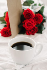 cup of coffee and a bouquet of red roses, envelope