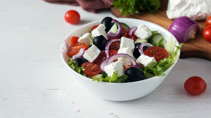 Fresh Greek salad in a white bowl