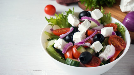 Greek salad with fresh vegetables, feta cheese and black olives