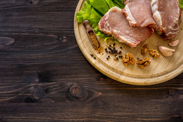 Slices of raw meat. Pork escalope on a wooden board.
