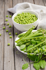 Fresh green peas on rustic wooden background, selective focus