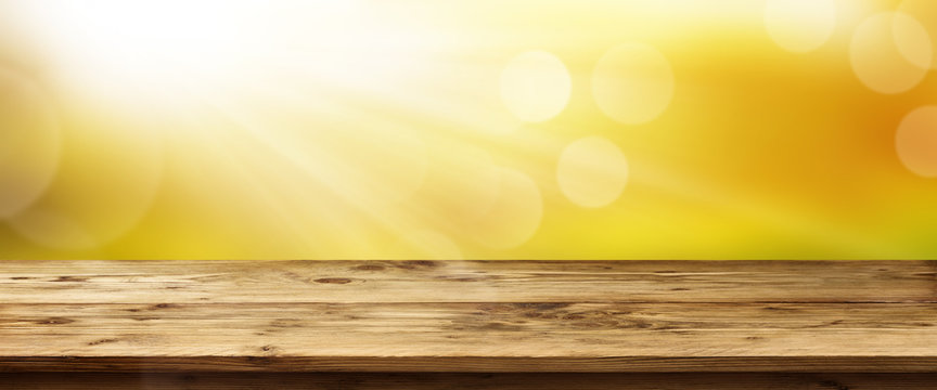 Spring background with sunrise and table