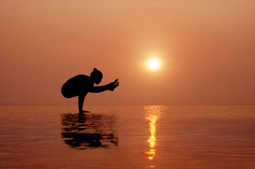 Yoga on the beach at sunset. Different correct asanas set in my portfolio