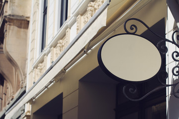 Fototapeta premium round empty signboard on a building with classical architecture