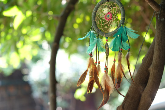 Soft focus dream catcher blue coral and natural bokeh background selective focus and blurry. Native american dream catcher. (Vintage style) boho chic, ethnic amulet.