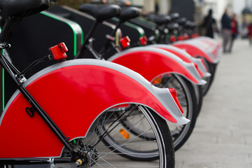 Fototapeta na wymiar city bike stand with red bicycles