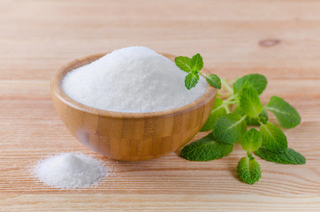 birch sugar xylitol in a wood bowl with mint on wooden