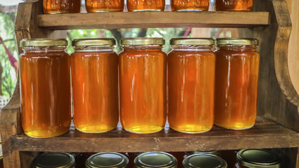 Flowery yellow honey in glass jar
