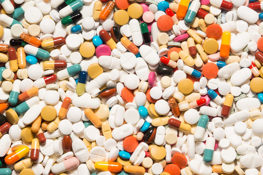 Multiple pills depicting medical treatment or pahrmaceutical industry. High resolution image.