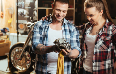 Happy smiling man showing detail to his girlfriend