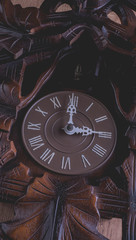 Cuckoo clock hanging on a rustic wooden wall