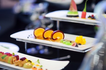Molecular modern cuisine. Various fancy dishes on white plates in a restaurant.