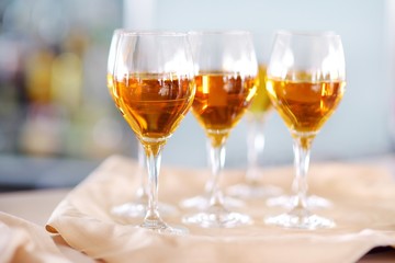 Few glasses of wine, champagne or another alcoholic beverage on a table