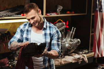Happy looking young man polishing detail