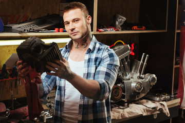 Delighted master standing near table with tools