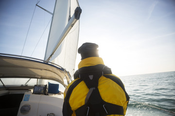 Rear View Of Mature Man Sailing On Yacht