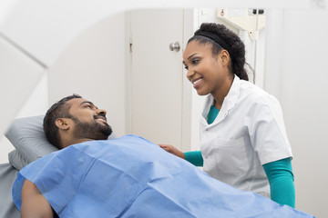 Medical Professional Preparing Man For X-ray Scan In Hospital