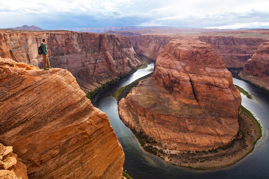 Traveler man on the background of the canyon Horseshoe bend, Arizona, USA. Travel concept, scenic view
