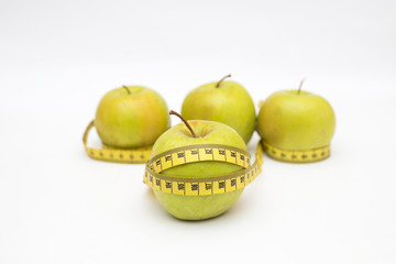 Green apple core and measuring tape. Diet concept