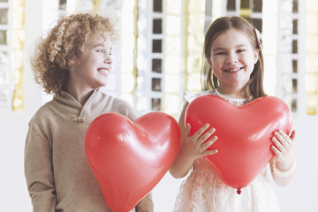 Boy and girl with hearts