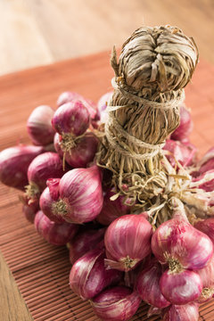 close up shallots on wood and bamboo background