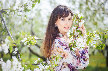 Naklejka premium woman in a cherry garden