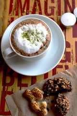 cappuccino with cookies and on the yellow red table