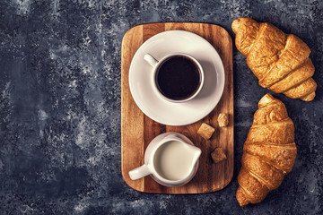 Croissants and coffee on a dark background