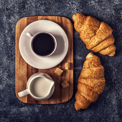 Croissants and coffee on a dark background