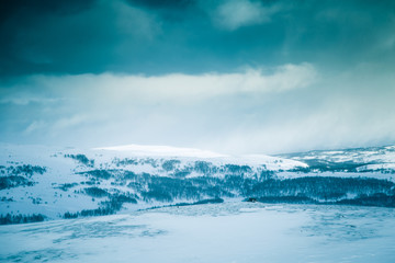 A beautiful winter landscape with mountains in the distance