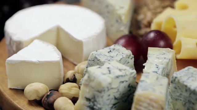 Cheese platter with nuts and grapes on the table. dolly video