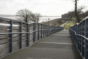 Cycleway and pedestrian foothpath acrooss rail lines to the Exe Estuary footpath near Starcross in South devon England UK