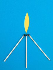 Illustration of Three Lit Matches Against a Blue Background