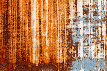 A background of peeling paint and rusty old metal