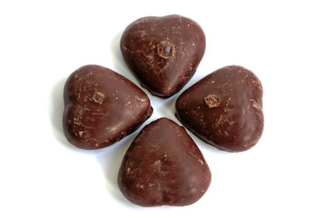 Chocolate covered gingerbread hearts on a white background