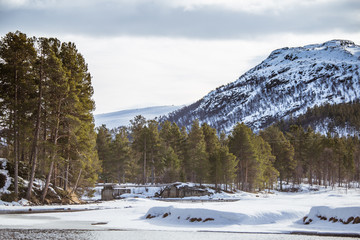 A beautiful landscape with a frozen river in the Norwegian winter