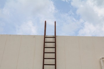Staircase old vertical industrial metal rusted. to Water tank no safety rails