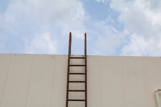 Staircase old vertical industrial metal rusted. to Water tank no safety rails