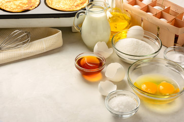 Ingredients for making pancakes on a white background. Copy space.