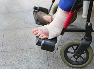 injured ankle with bandage of woman on wheelchair