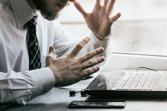 Young businessman sitting behind crumpled paper with expectations Emotion