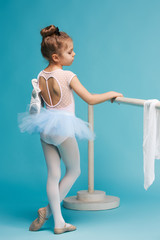 The little balerina dancer on blue background © master1305