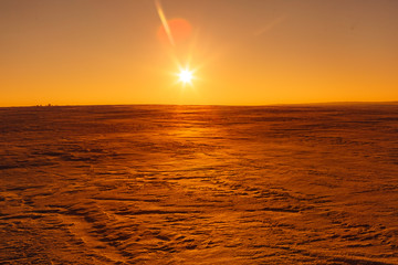 Martian sunset (Mars planet) red landscape. Looks like cold desert on Mars. A huge field of ice