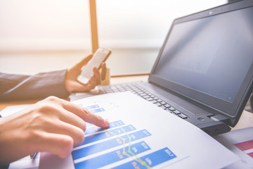 Businessman working with laptop and graph data at office 