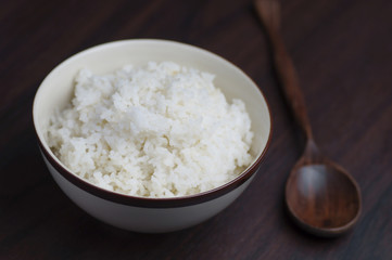 Thai riec in bowl with wooden spoon on table