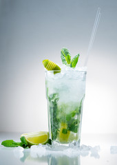 Mojito cocktail with lime and mint in highball glass